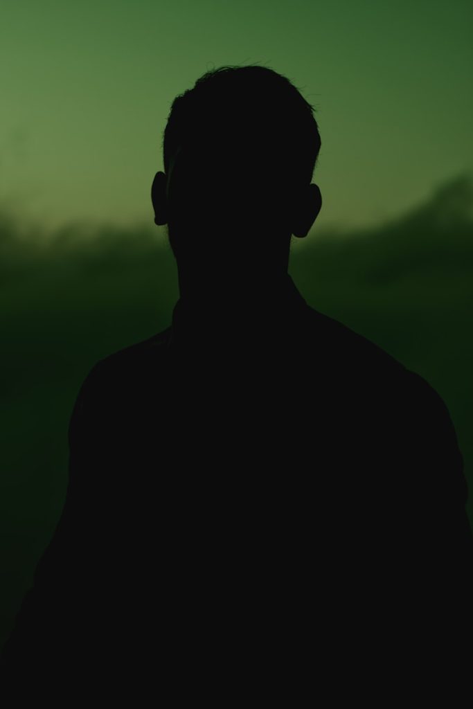 a silhouette of a man in the dark